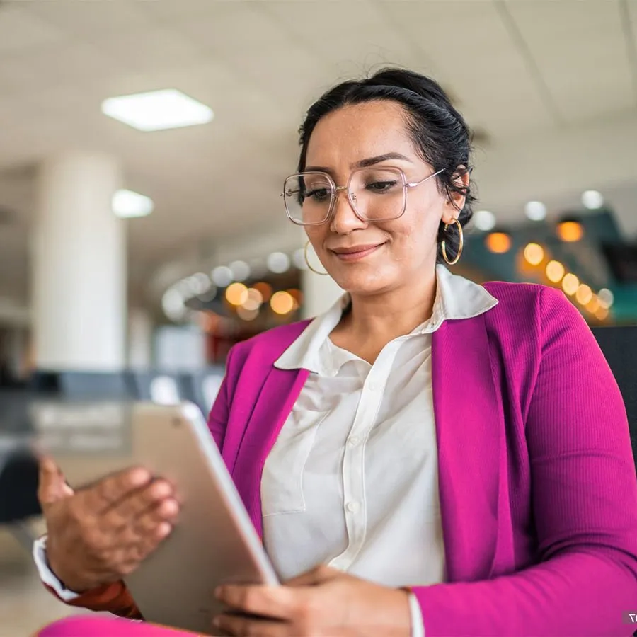 Latina holding iPad, confident face